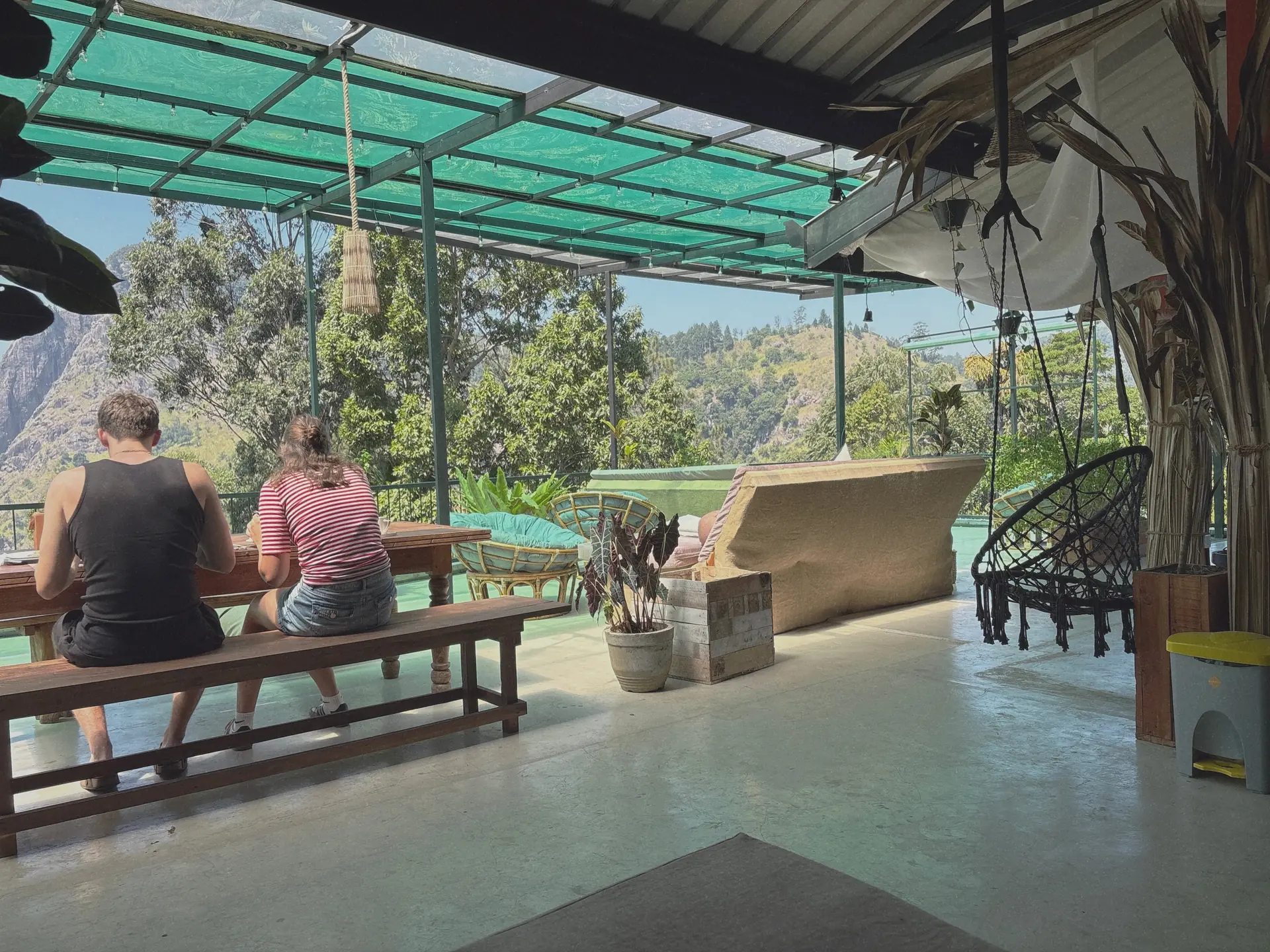Guests sitting on the Beyond Nomad terrace overlooking the hills